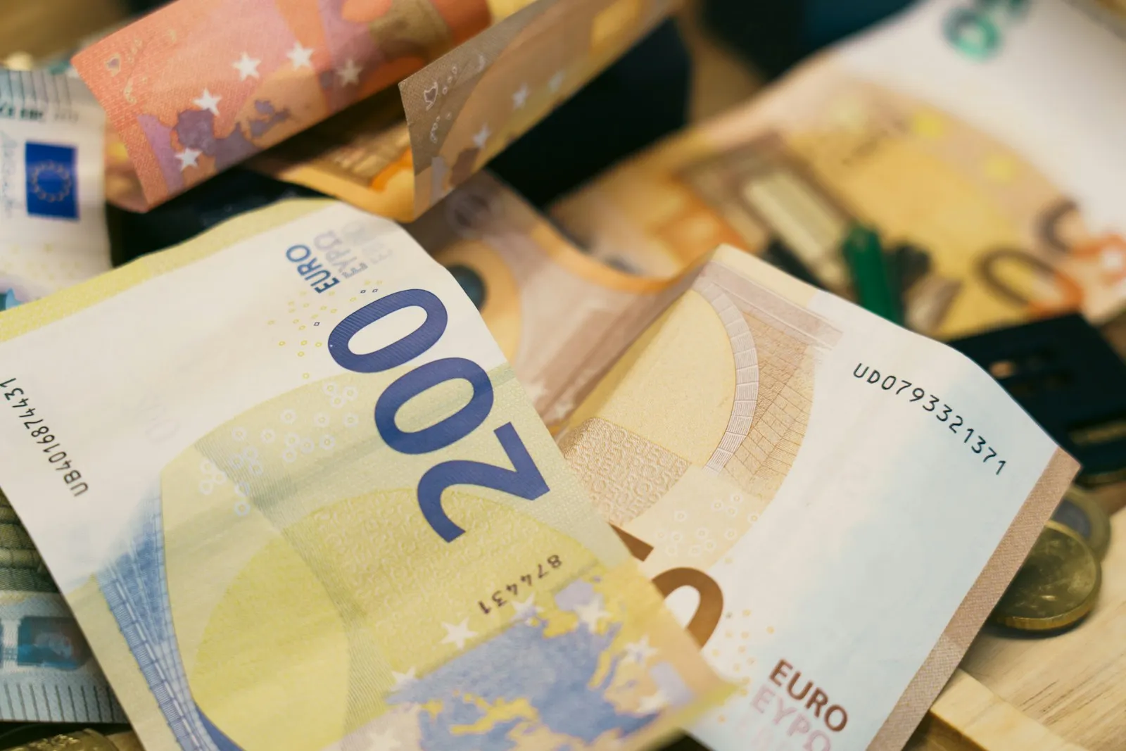 A pile of euro banknotes and coins